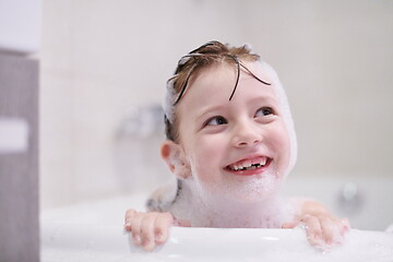 Image showing little girl in bath playing with soap foam