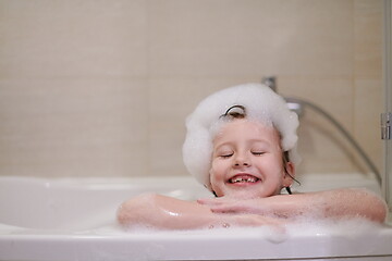 Image showing little girl in bath playing with soap foam