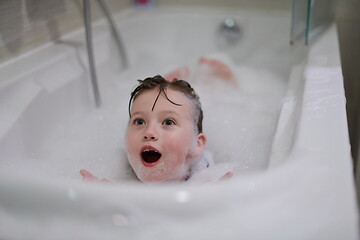 Image showing little girl in bath playing with soap foam