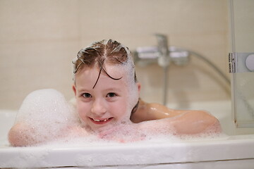 Image showing little girl in bath playing with soap foam