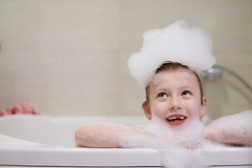 Image showing little girl in bath playing with soap foam