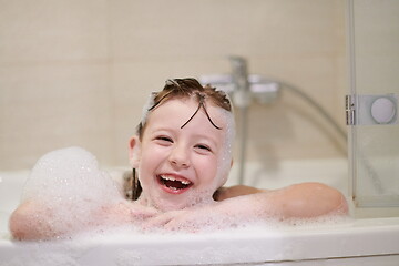 Image showing little girl in bath playing with soap foam