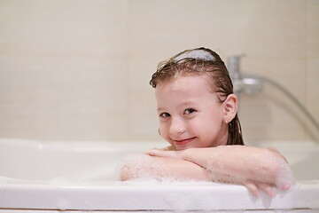 Image showing little girl in bath playing with soap foam