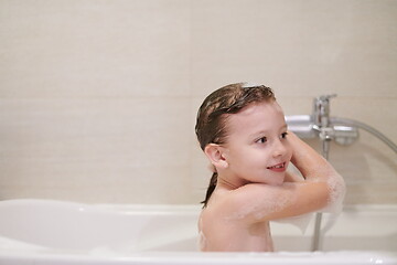 Image showing little girl in bath playing with soap foam