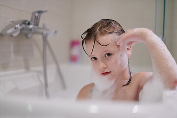 Image showing little girl in bath playing with soap foam