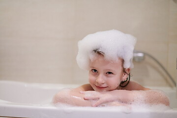 Image showing little girl in bath playing with soap foam