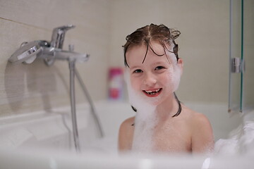 Image showing little girl in bath playing with soap foam