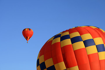 Image showing Two vivid red hot air balloons