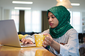 Image showing african muslim business woman drinking tea