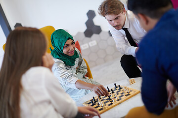 Image showing multiethnic group of business people playing chess