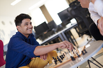 Image showing multiethnic group of business people playing chess