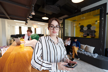 Image showing portrait of businesswoman with glasses using mobile phone