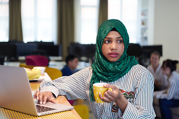 Image showing african muslim business woman drinking tea