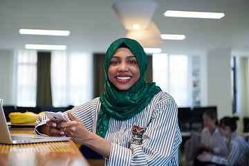 Image showing african muslim business woman using mobile phone