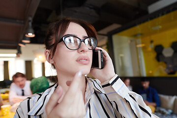 Image showing portrait of businesswoman with glasses using mobile phone