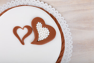 Image showing valentine love cake with hearts on wooden background