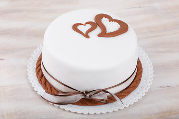 Image showing valentine love cake with hearts on wooden background