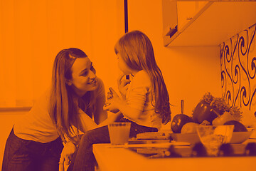 Image showing happy daughter and mom in kitchen