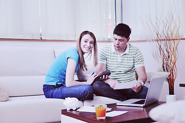 Image showing young couple working on laptop at home