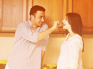 Image showing happy young couple have fun in modern kitchen