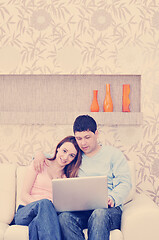 Image showing young couple working on laptop at home