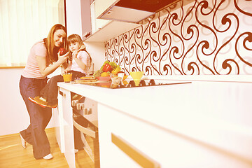 Image showing happy daughter and mom in kitchen