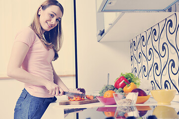 Image showing happy young  woman with apple in kitchen