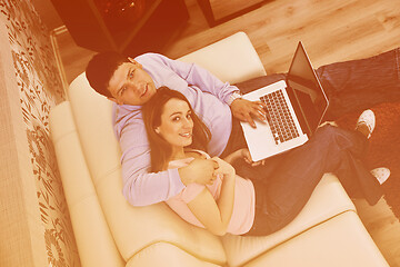 Image showing young couple working on laptop at home
