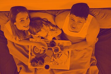 Image showing happy young family eat breakfast in bed