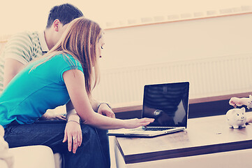 Image showing young couple working on laptop at home