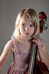 Image showing Portrait of a young teenager girl in studio with a cello