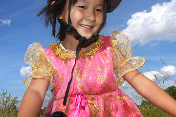 Image showing Cute girl cycling with a princess outfit