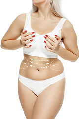 Image showing Female body with the drawing arrows. Fat lose, liposuction and cellulite removal concept