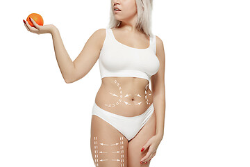 Image showing Female body with the drawing arrows. Fat lose, liposuction and cellulite removal concept