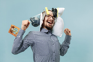 Image showing Tired man sleeping at home having too much work. Bored businessman with pillow