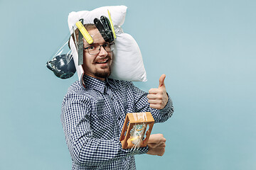 Image showing Tired man sleeping at home having too much work. Bored businessman with pillow