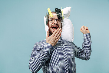 Image showing Tired man sleeping at home having too much work. Bored businessman with pillow