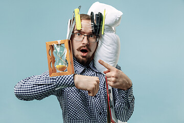 Image showing Tired man sleeping at home having too much work. Bored businessman with pillow