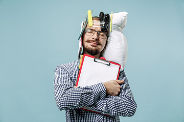 Image showing Tired man sleeping at home having too much work. Bored businessman with pillow