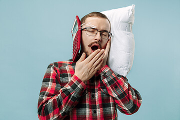 Image showing Tired man sleeping at home having too much work. Bored businessman with pillow