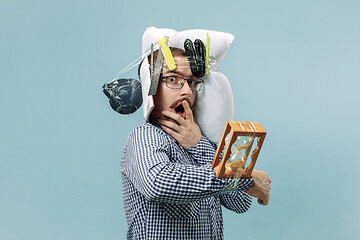 Image showing Tired man sleeping at home having too much work. Bored businessman with pillow