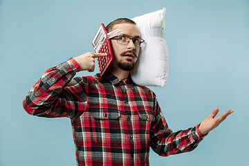 Image showing Tired man sleeping at home having too much work. Bored businessman with pillow