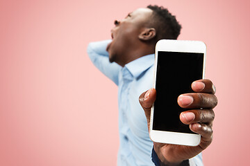 Image showing Beautiful man looking suprised and bewildered isolated on pink