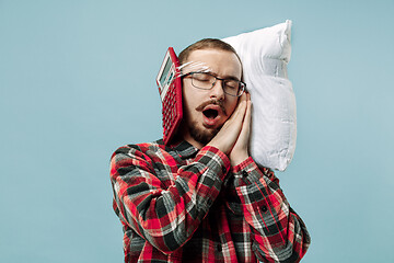 Image showing Tired man sleeping at home having too much work. Bored businessman with pillow