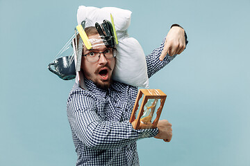 Image showing Tired man sleeping at home having too much work. Bored businessman with pillow