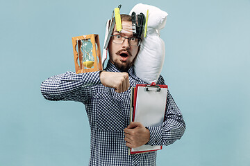 Image showing Tired man sleeping at home having too much work. Bored businessman with pillow