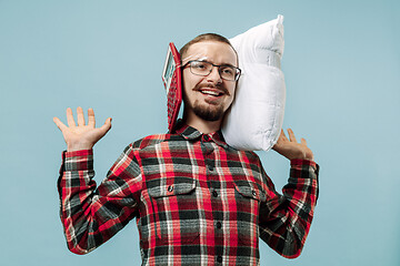 Image showing Tired man sleeping at home having too much work. Bored businessman with pillow