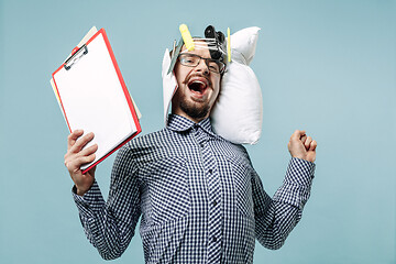 Image showing Tired man sleeping at home having too much work. Bored businessman with pillow