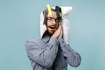 Image showing Tired man sleeping at home having too much work. Bored businessman with pillow