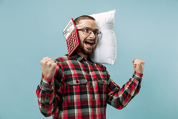 Image showing Tired man sleeping at home having too much work. Bored businessman with pillow